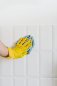 Person Cleaning Tiles Cleaning With A Microfiber Cloth